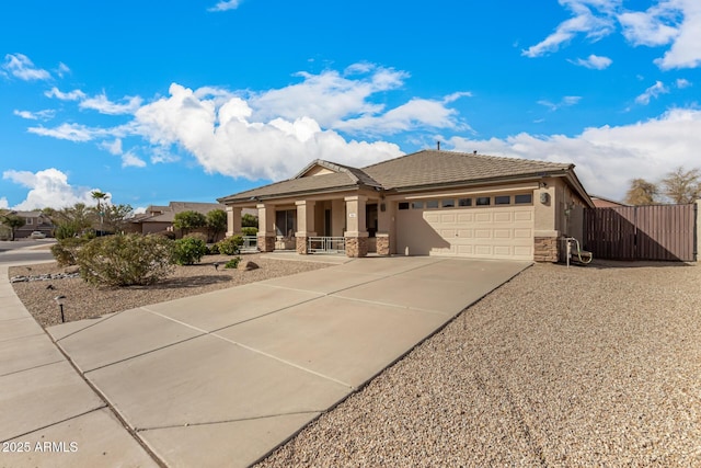 view of front facade featuring a garage, concrete driveway, stone siding, and stucco siding