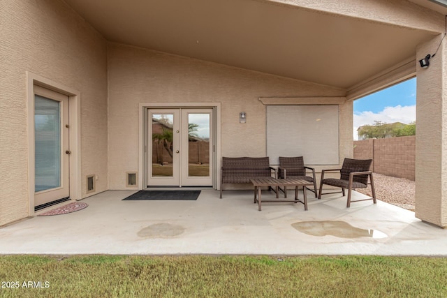 view of patio with french doors and fence