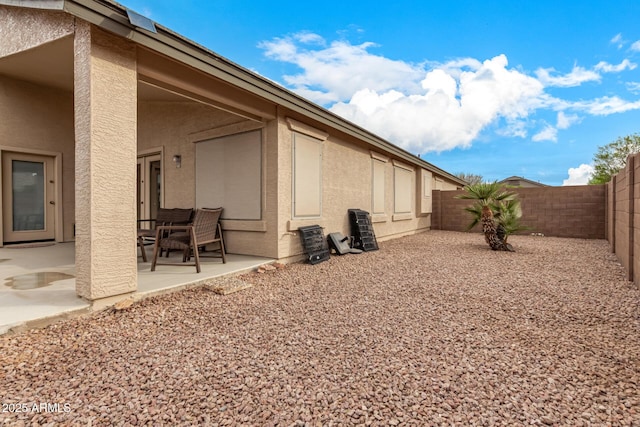 exterior space featuring a fenced backyard and a patio