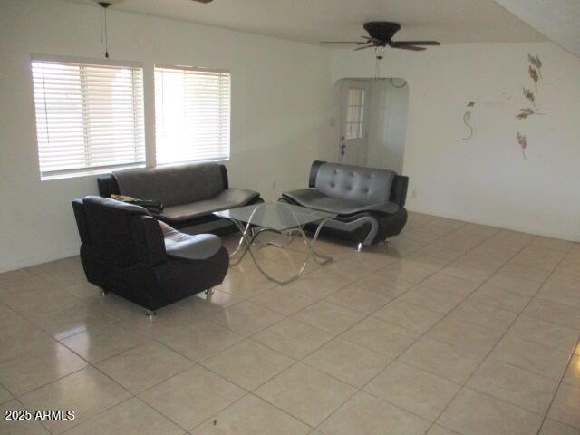 living room with a ceiling fan and light tile patterned floors