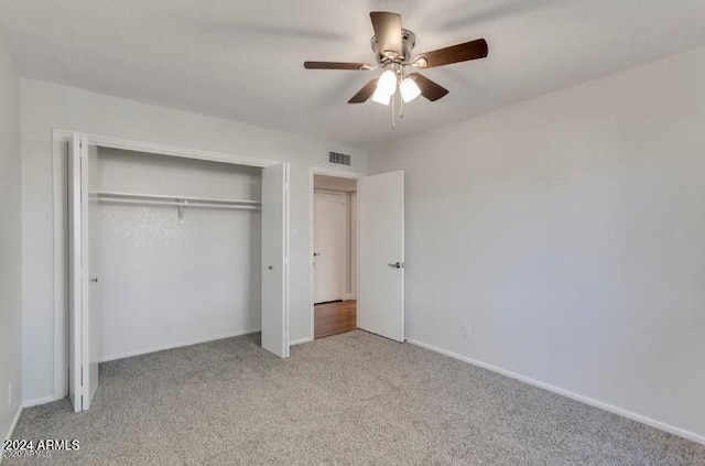 unfurnished bedroom with a closet, ceiling fan, and light colored carpet