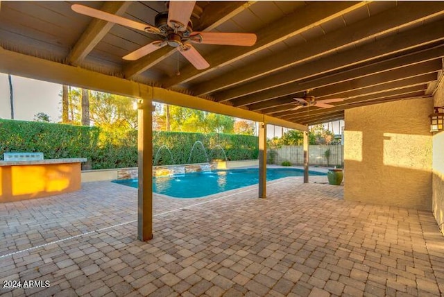 view of swimming pool featuring pool water feature, exterior bar, and a patio