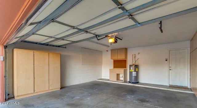 garage with water heater and a garage door opener