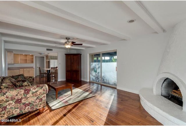 living room featuring beamed ceiling, wood-type flooring, and ceiling fan