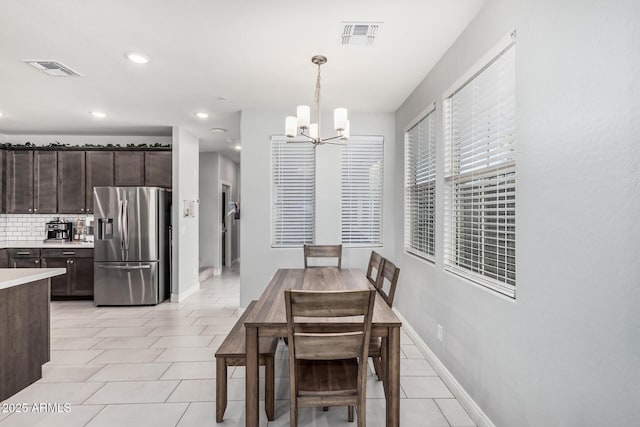 2640 N Heritage St, Buckeye, AZ 85396 - dining space featuring visible vents, a chandelier, and light tile patterned floors