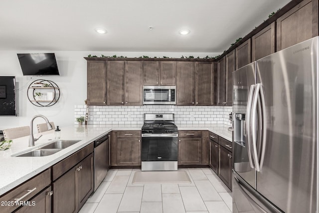 2640 N Heritage St, Buckeye, AZ 85396 - kitchen with tasteful backsplash, dark brown cabinetry, a sink, and stainless steel appliances