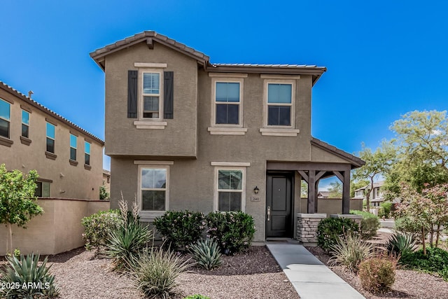 2640 N Heritage St, Buckeye, AZ 85396 - view of front facade featuring a tiled roof, stucco siding, and fence