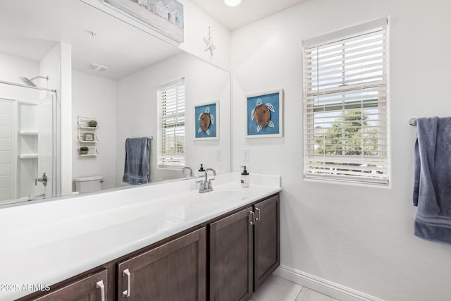 2640 N Heritage St, Buckeye, AZ 85396 - full bathroom featuring a shower, baseboards, toilet, vanity, and tile patterned flooring