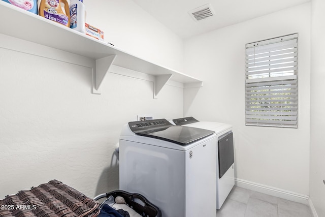 2640 N Heritage St, Buckeye, AZ 85396 - washroom with washer and clothes dryer, light tile patterned floors, baseboards, visible vents, and laundry area