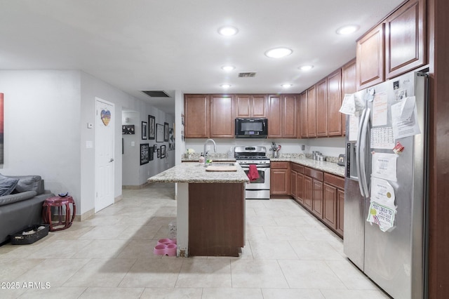 kitchen featuring appliances with stainless steel finishes, recessed lighting, visible vents, and a sink