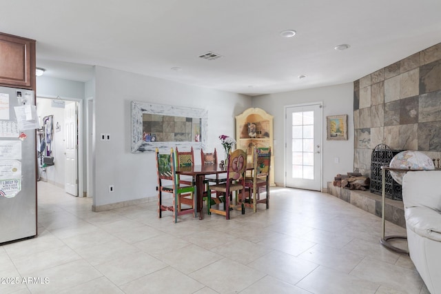 dining area with a fireplace and visible vents