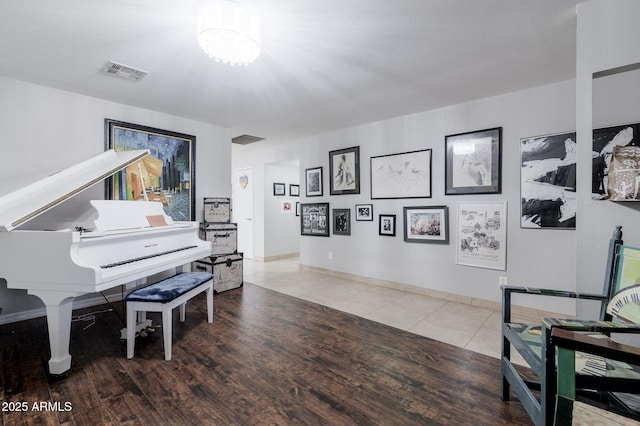 sitting room featuring baseboards, visible vents, and tile patterned floors