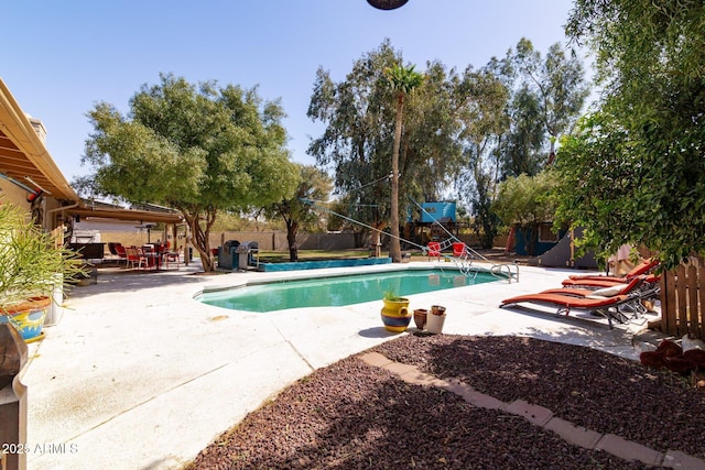 view of swimming pool featuring a fenced backyard, a fenced in pool, and a patio