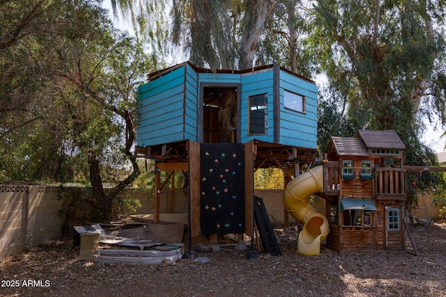 view of jungle gym featuring fence