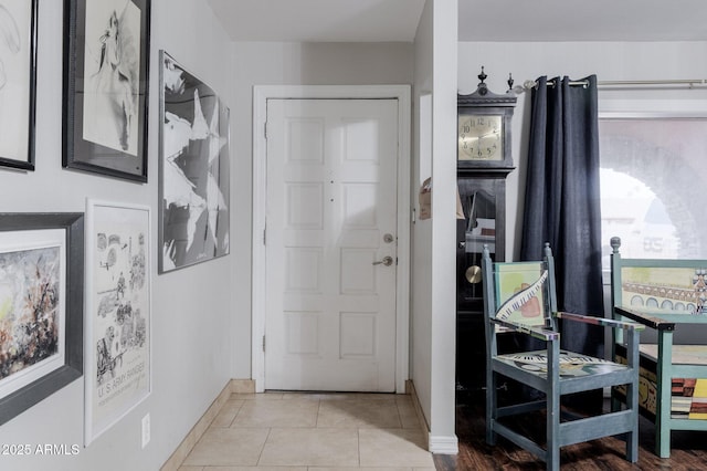 tiled foyer with baseboards