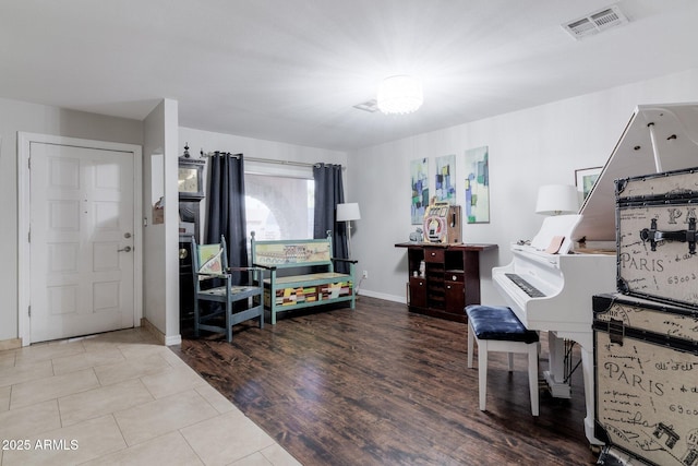 interior space featuring visible vents, baseboards, and wood finished floors