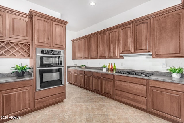 kitchen featuring light tile patterned floors and appliances with stainless steel finishes