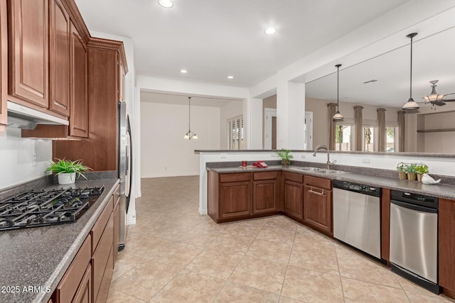 kitchen with ceiling fan, pendant lighting, sink, stainless steel appliances, and light tile patterned floors