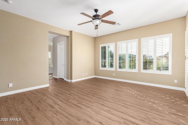 unfurnished room with ceiling fan and hardwood / wood-style floors