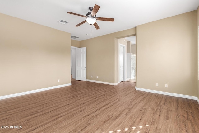 spare room with light wood-type flooring and ceiling fan