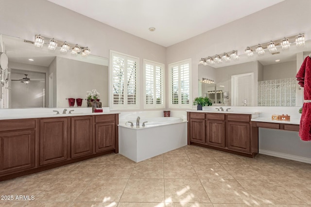 bathroom featuring tile patterned flooring, vanity, a tub, and ceiling fan