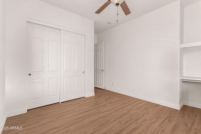 unfurnished bedroom featuring a closet, light hardwood / wood-style flooring, and ceiling fan