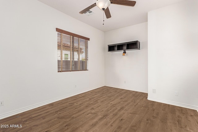 empty room with ceiling fan and hardwood / wood-style floors