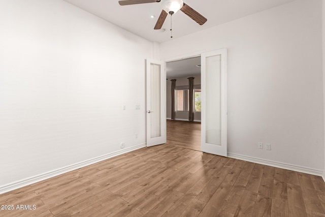 spare room featuring ceiling fan, wood-type flooring, and french doors