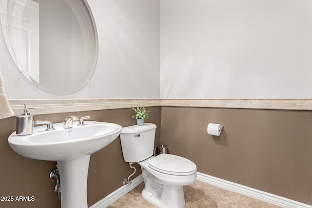 bathroom with toilet and tile patterned flooring