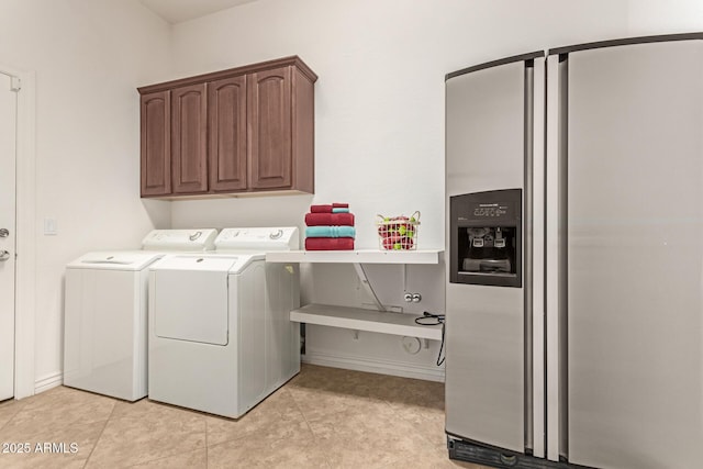 laundry room with cabinets, separate washer and dryer, and light tile patterned floors