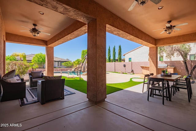 view of patio / terrace featuring ceiling fan, a fenced in pool, and an outdoor hangout area