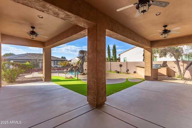 view of patio with exterior kitchen and ceiling fan