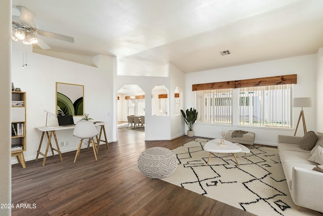 living room with baseboards, visible vents, arched walkways, a ceiling fan, and wood finished floors