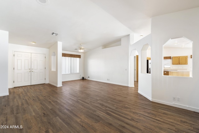 unfurnished living room featuring baseboards, visible vents, dark wood finished floors, and a ceiling fan