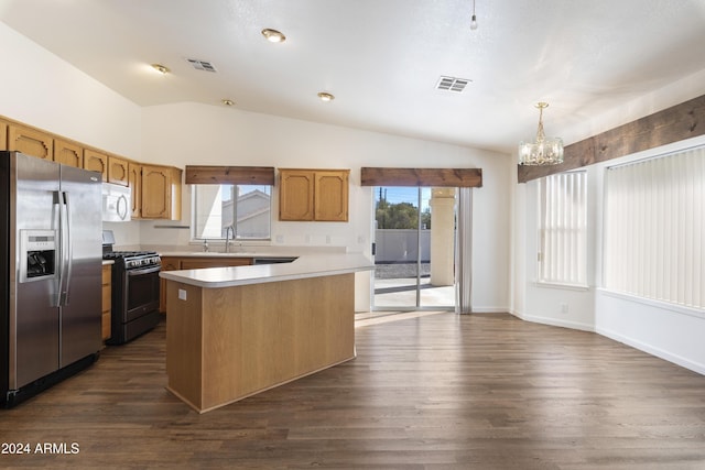 kitchen with vaulted ceiling, light countertops, appliances with stainless steel finishes, and visible vents