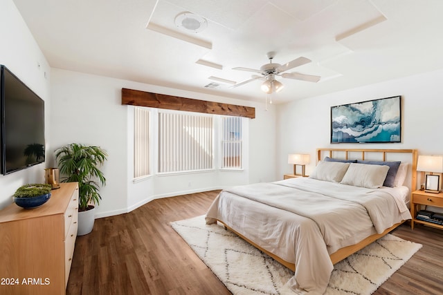 bedroom with visible vents, ceiling fan, baseboards, and wood finished floors