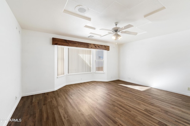 spare room with ceiling fan, wood finished floors, visible vents, and baseboards