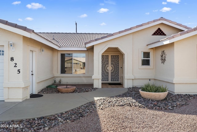 doorway to property with a tile roof