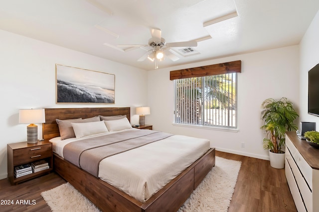 bedroom with visible vents, ceiling fan, baseboards, and wood finished floors