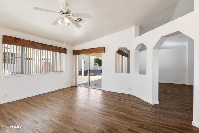 empty room with a ceiling fan, baseboards, vaulted ceiling, and wood finished floors