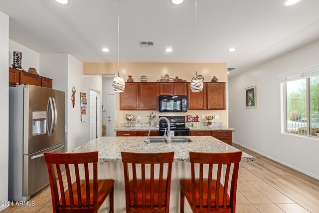 17540 W Glenhaven Dr, Goodyear, AZ 85338 - kitchen with recessed lighting, decorative light fixtures, black appliances, and visible vents