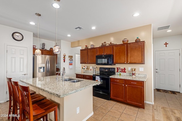 17540 W Glenhaven Dr, Goodyear, AZ 85338 - kitchen with a sink, visible vents, black appliances, and a kitchen breakfast bar