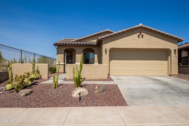 17540 W Glenhaven Dr, Goodyear, AZ 85338 - mediterranean / spanish home with a tile roof, driveway, stucco siding, an attached garage, and fence