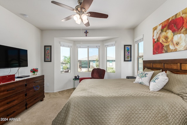 bedroom with light colored carpet and ceiling fan