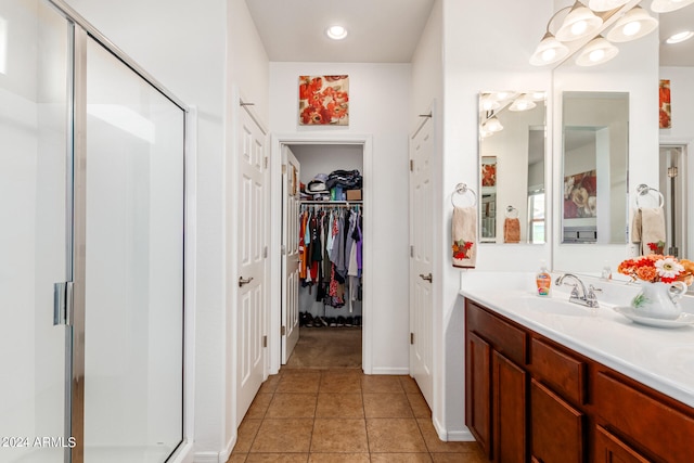 bathroom with vanity, tile patterned flooring, and a shower with door