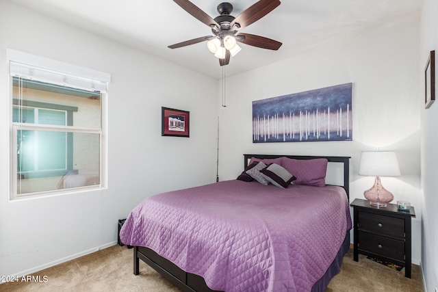 bedroom featuring light carpet and ceiling fan