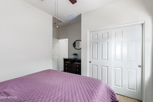 carpeted bedroom with ceiling fan and a closet