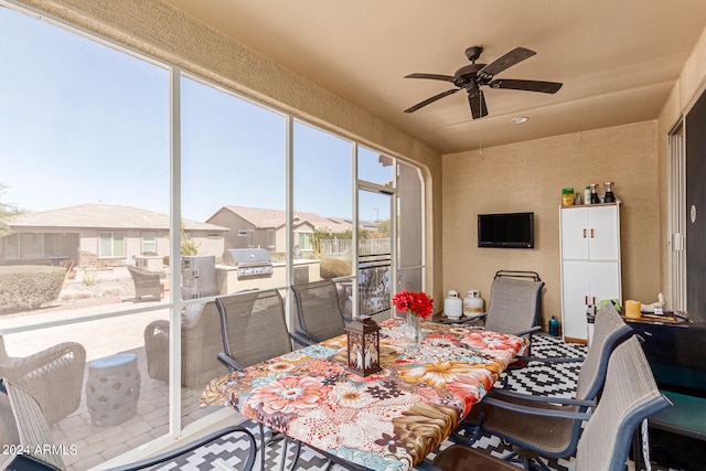 sunroom / solarium featuring ceiling fan