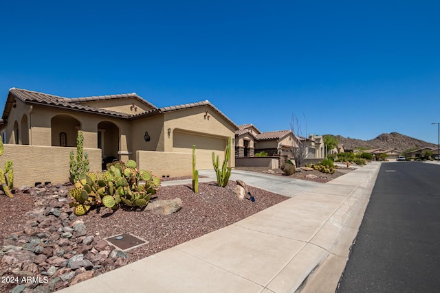 17540 W Glenhaven Dr, Goodyear, AZ 85338 - mediterranean / spanish home with fence, a garage, concrete driveway, a tile roof, and stucco siding