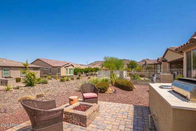 17540 W Glenhaven Dr, Goodyear, AZ 85338 - view of patio / terrace featuring area for grilling, a fire pit, fence, and a grill